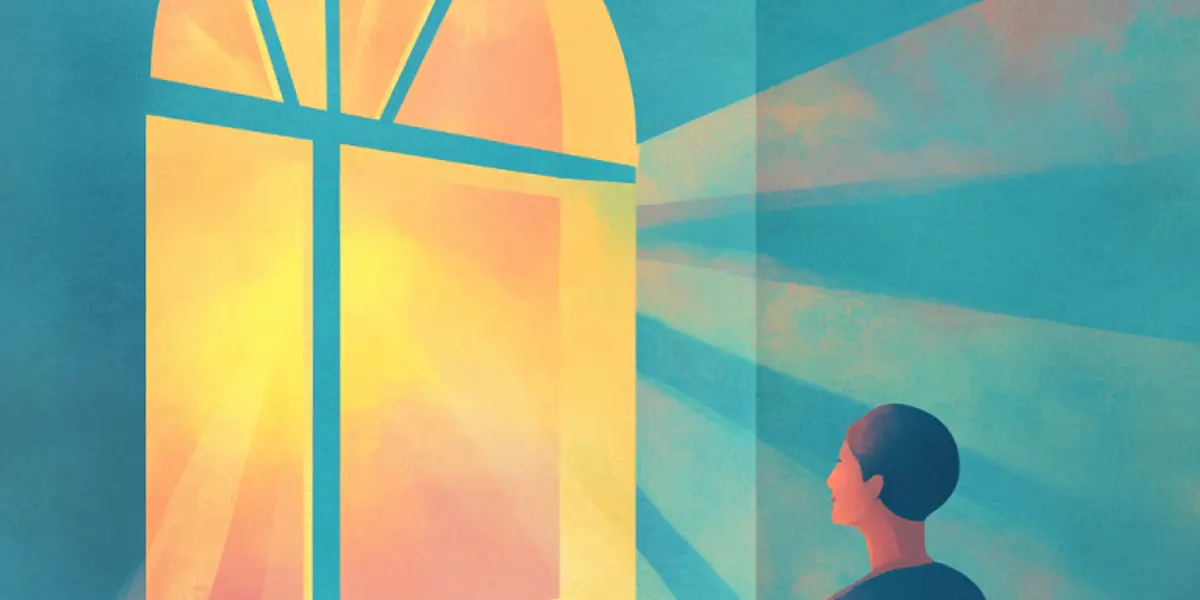 A person gazes up at a glowing arched window shaped like a cross, with warm light streaming through.