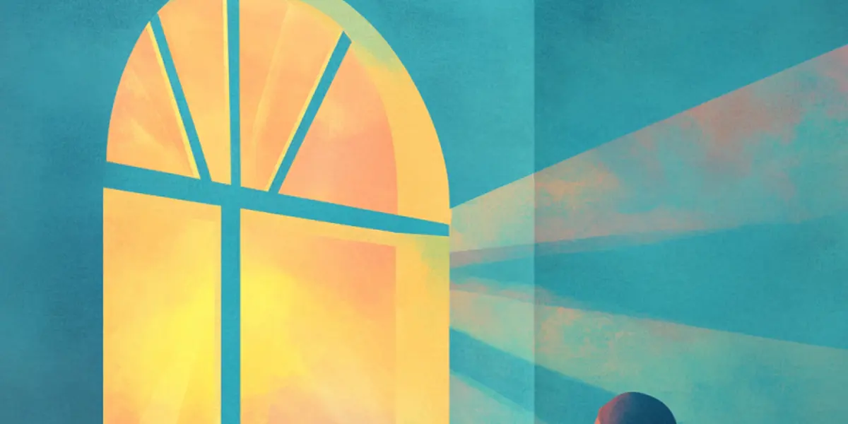 A person gazes up at a glowing arched window shaped like a cross, with warm light streaming into a teal room.