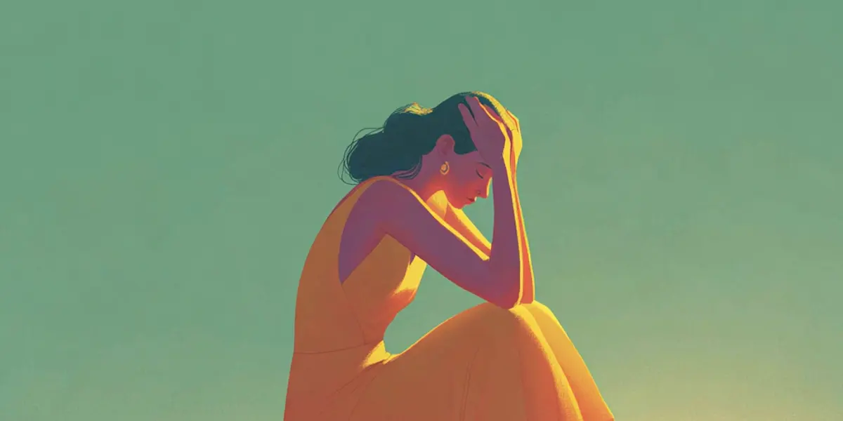 A woman in an orange dress crouches with her head in her hand in a posture of shame, lit by a soft warm glow.
